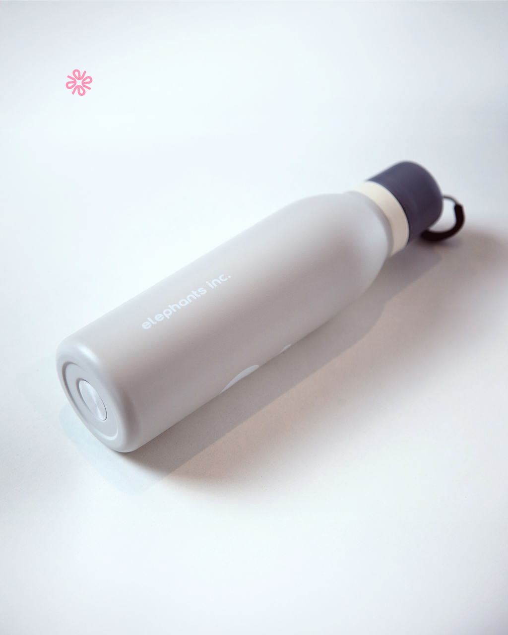 White water bottle with purple lid on a white background